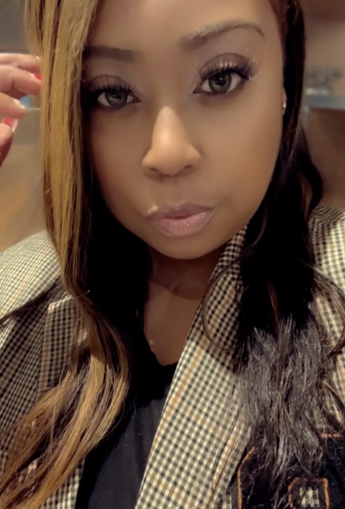 Close-up portrait of Ms. Williams in a checked jacket