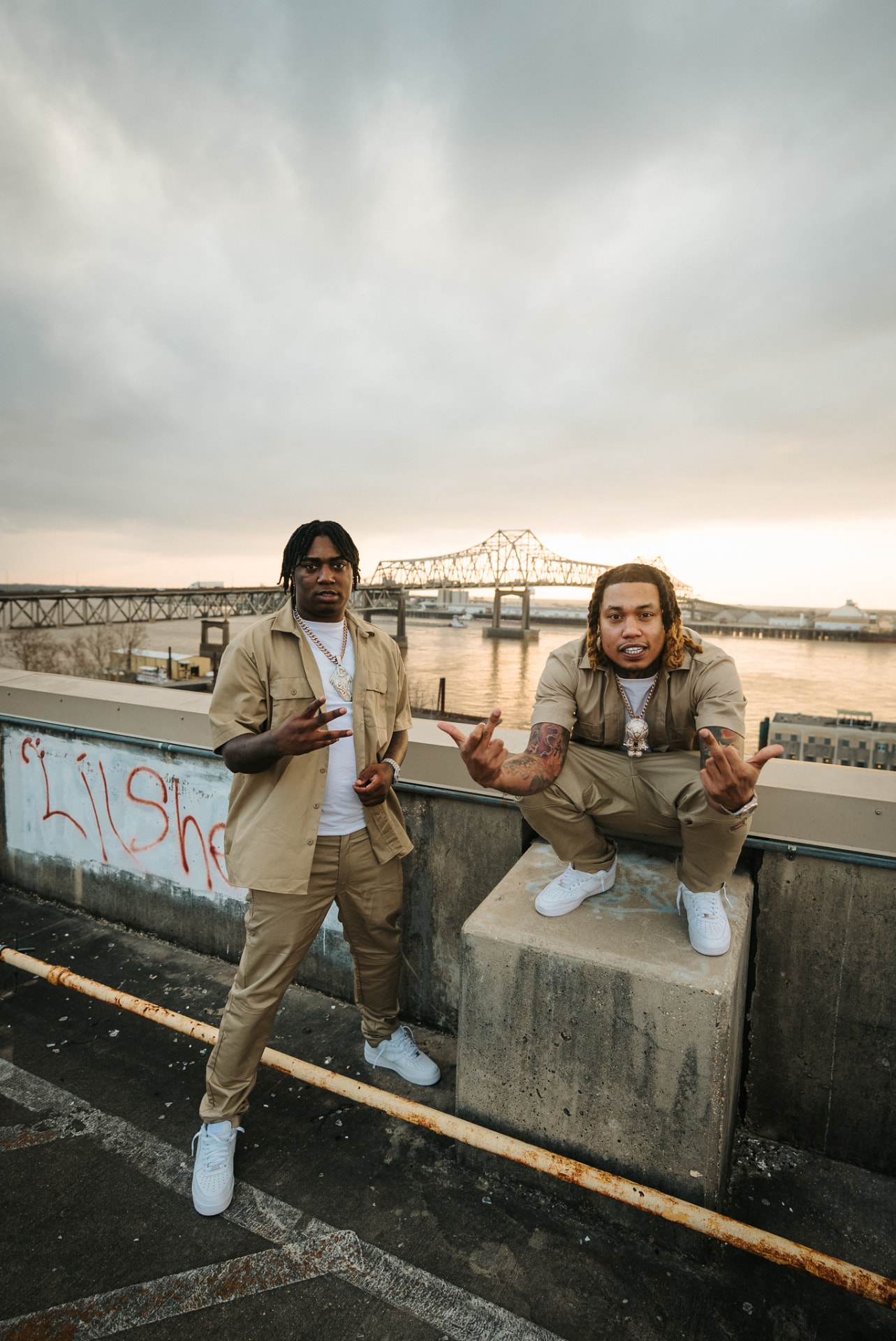 Two artists posing on a rooftop